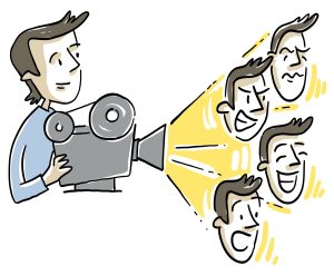 Une personne qui tient une caméra, de modèle classique, d’où sort une projection lumineuse avec 4 visages reflétant chacune la peur, la joie, la colère, et la tristesse.